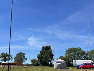 Grantham Amateur Radio Club members operating portable amateur radio stations with HF and VHF antennas during a sunny field day in Lincolnshire.